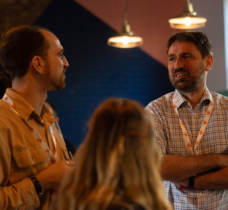 Team members talking at a CameraForensics community event